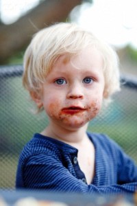 Young boy with his mouth smeared with chocolate