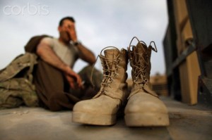 A soldier from the U.S. Army's 1st Platoon, 18th Engineer Company, Task Force Arrowhead wakes from his bed on the back of an armoured truck at FOB Mizan in Afghanistan